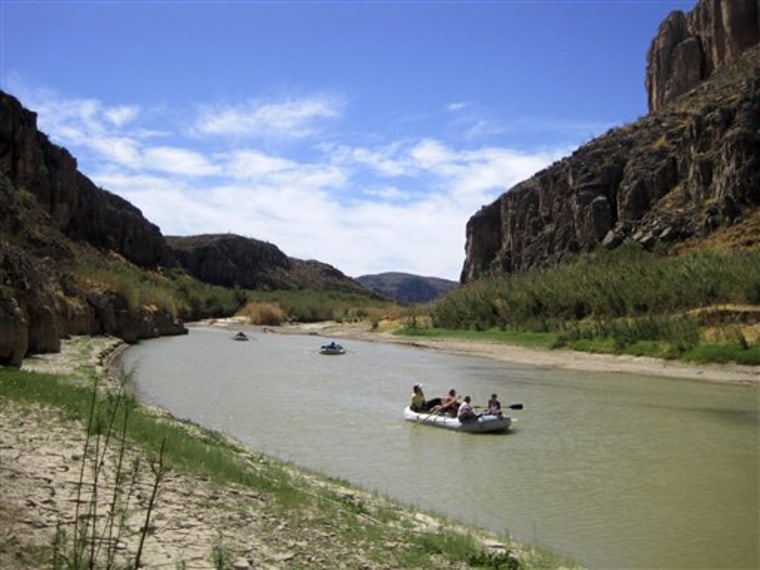 Rafts piloted by guides from Far Flung Outdoor Center of Terlingua, Texas, float through a canyon carved by the Rio Grande on March 25 through Big Bend National Park. The river outfitter and San Antonio chef Francois Maeder conduct unique gourmet trips on the river. 